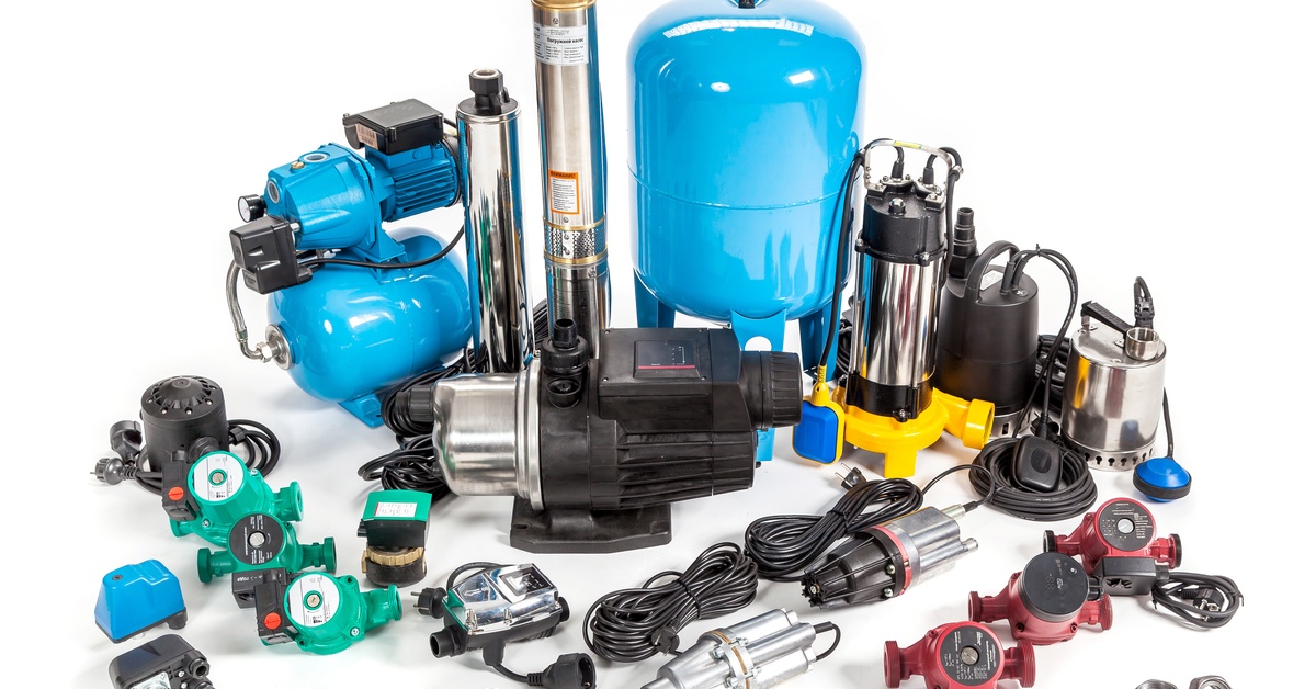 Water pumps and various accessories, including cords and screws, sit in a pile against a white backdrop.