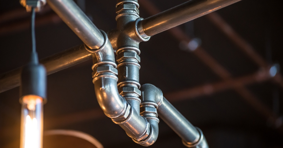 A small pipe system that leads in three different directions and contains cross fittings, elbows, and tees.